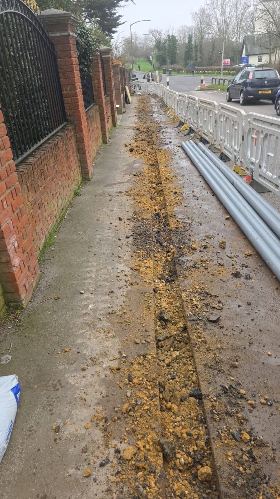 Street-side groundwork in progress along a footpath