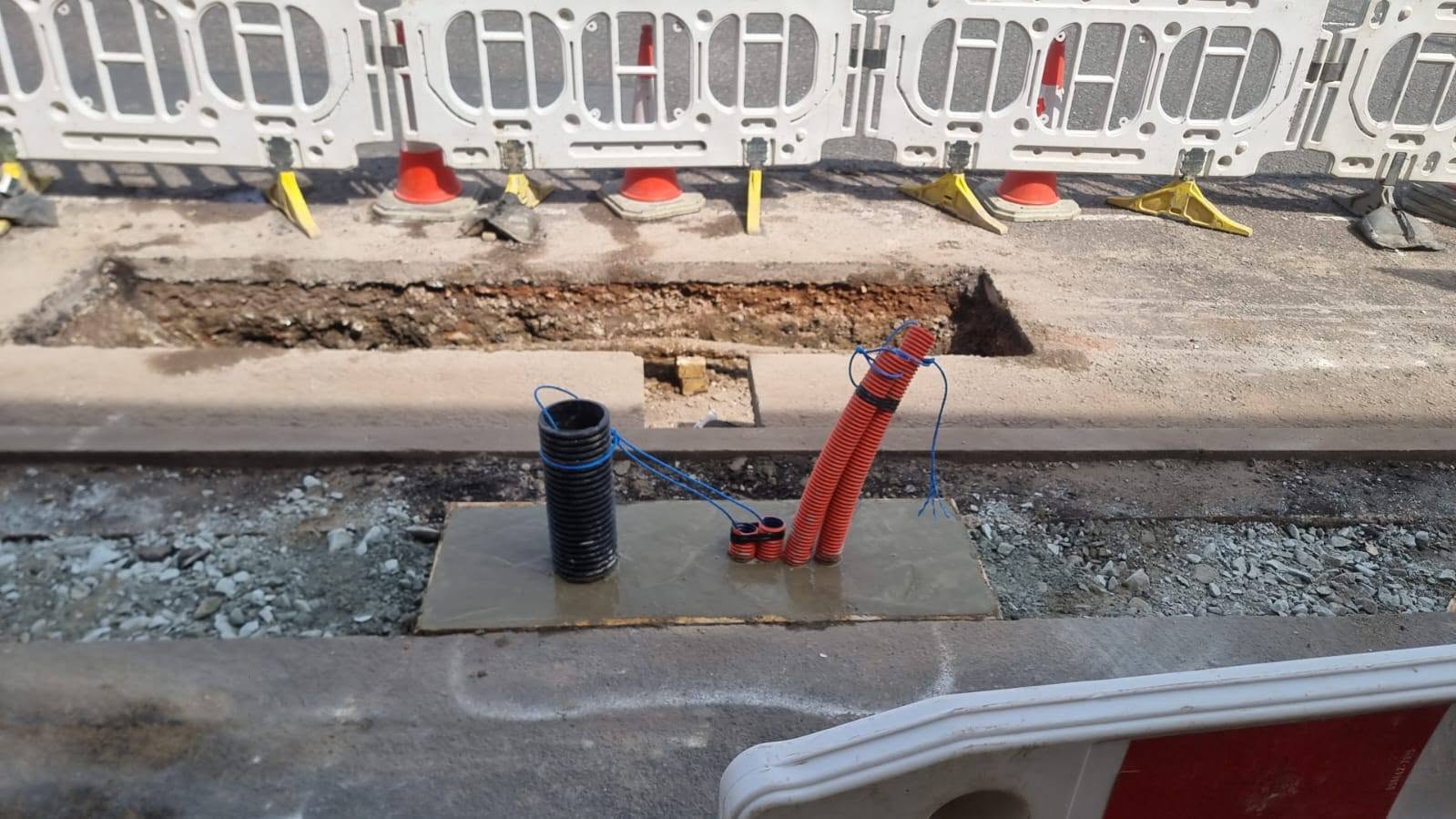 Installed utility ducts emerging from a prepared ground-level opening